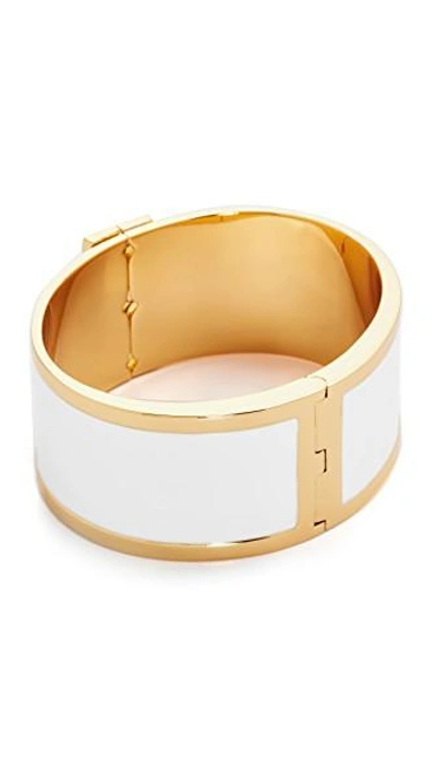 Shop Tory Burch Enamel Raised Logo Wide Cuff Bracelet In New Ivory/tory Gold