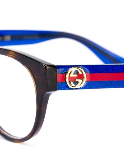 Shop Gucci Interlocking Gg Oval-frame Glasses