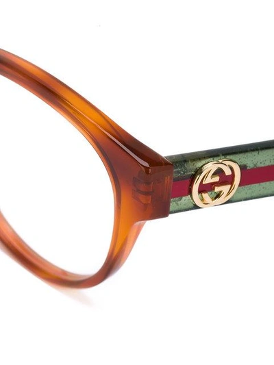 Shop Gucci Cat Eye Glasses In Green