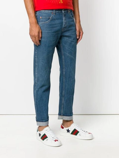 Shop Gucci Embroidered Tapered Jeans - Blue