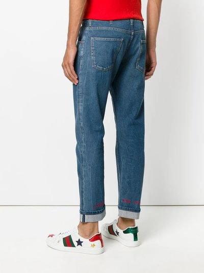 Shop Gucci Embroidered Tapered Jeans - Blue