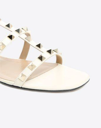 Shop Valentino Garavani Rockstud Calfskin Ankle Strap Flat Sandal In Light Ivory