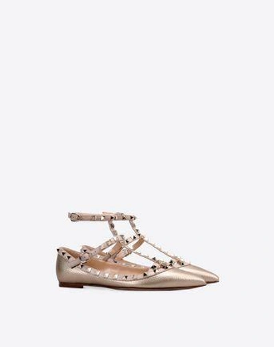 Shop Valentino Rockstud Metallic Grainy Calfskin Ankle Strap Ballet Flat In Gold