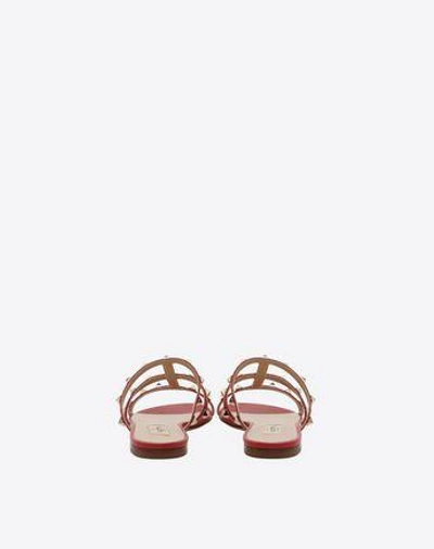 Shop Valentino Garavani Rockstud Flat Slide Sandal In Rosso