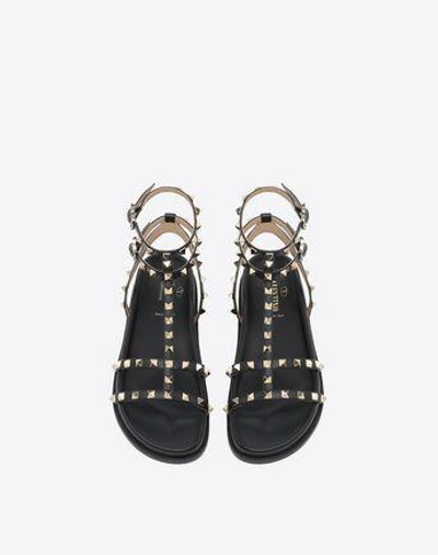 Shop Valentino Rockstud Ankle Strap Flat Sandal In Black