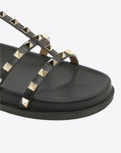 Shop Valentino Rockstud Ankle Strap Flat Sandal In Black