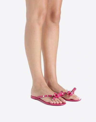 Shop Valentino Jelly Bow Rockstud Thong In Fuchsia