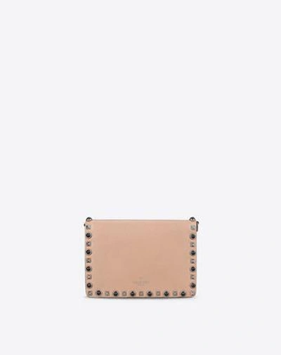 Shop Valentino Guitar Rockstud Rolling Small Cross Body Bag In Skin Color