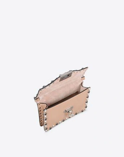 Shop Valentino Guitar Rockstud Rolling Small Cross Body Bag In Skin Color