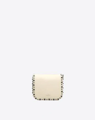 Shop Valentino Guitar Rockstud Rolling Cross Body Bag In Ivory