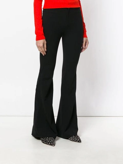 Shop Givenchy Long Flared Trousers In Black