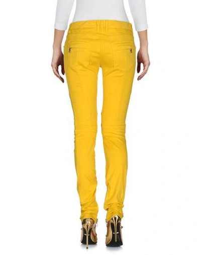Shop Balmain Jeans In Yellow