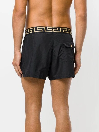 Shop Versace Greek Key Swim Shorts