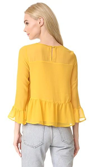 Shop Cupcakes And Cashmere Katlyn Peplum Blouse In Saffron Yellow