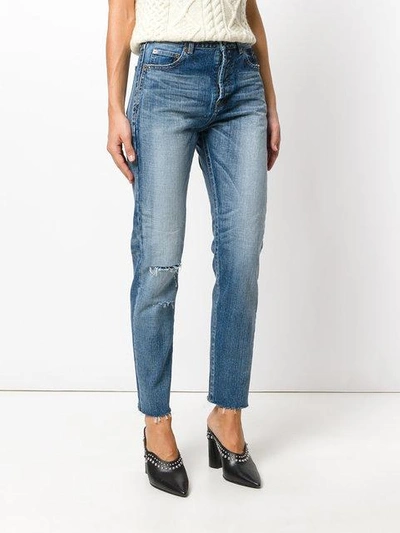 Shop Saint Laurent Distressed Tapered Fit Jeans In Blue