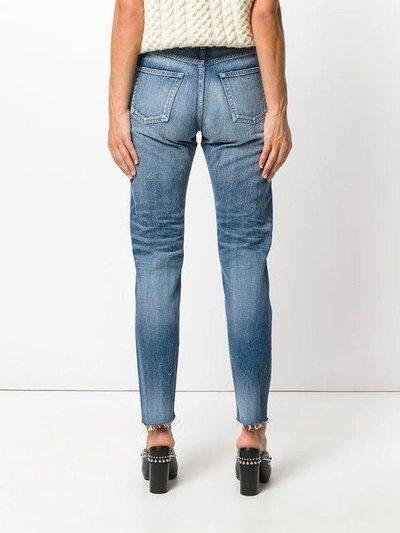 Shop Saint Laurent Distressed Tapered Fit Jeans In Blue