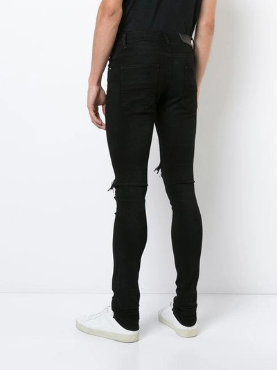 Shop Amiri - Distressed Skinny Jeans  In Black