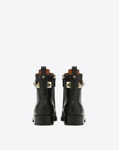 Shop Valentino Combat Boot In Black