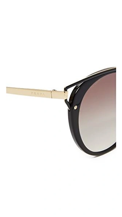 Shop Prada Wanderer Sunglasses In Black/grey