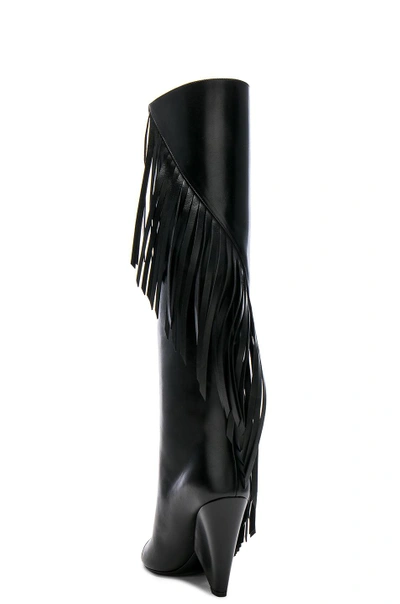 Shop Saint Laurent Niki Fringe Leather Boots In Black