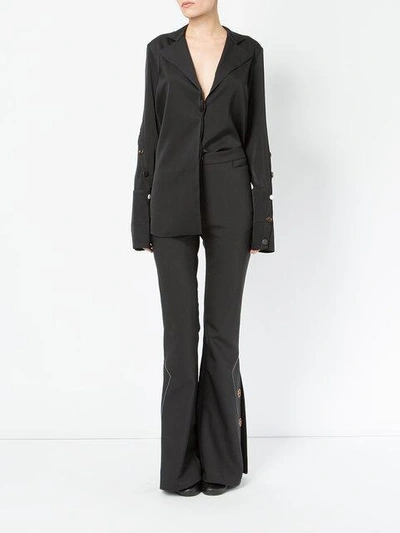 Shop Ellery Flared Button Trousers In Black