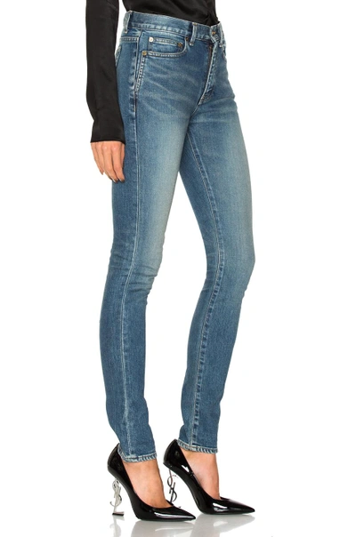 Shop Saint Laurent Medium Rise Jeans In Blue