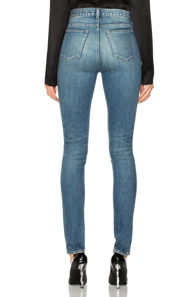 Shop Saint Laurent Medium Rise Jeans In Blue