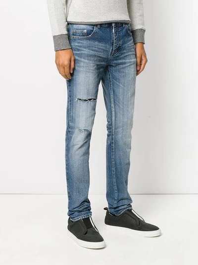 Shop Saint Laurent Distressed Denim Jeans In Blue