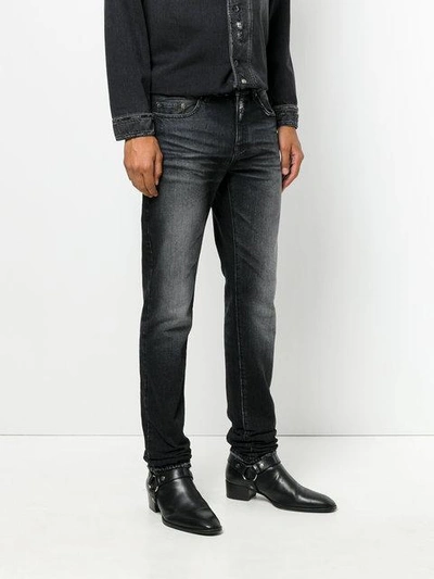 Shop Saint Laurent Distressed Trim Slim Fit Jeans In Black