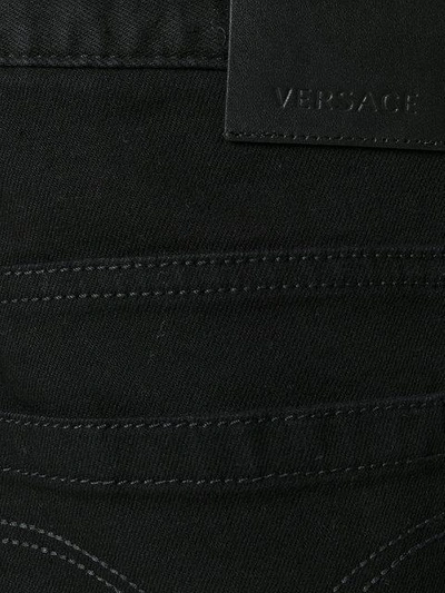 Shop Versace Slim Fit Jeans - Black