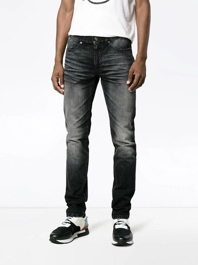 Shop Saint Laurent Washed Slim-fit Jeans In Black