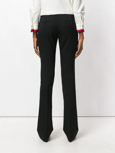 Shop Gucci Moth Embroidered Skinny Flared Trousers In Black
