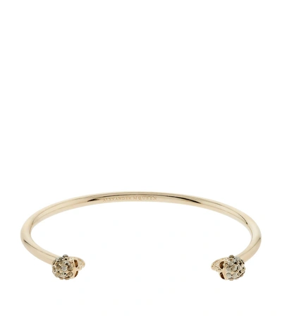 Shop Alexander Mcqueen Thin Skull Embellished Bracelet In Gold