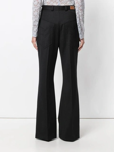 Shop Nina Ricci Leather-trimmed Flared Trousers - Black