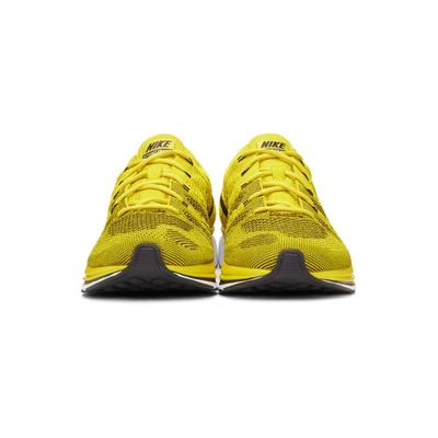 Shop Nike Yellow Flyknit Trainer Sneakers