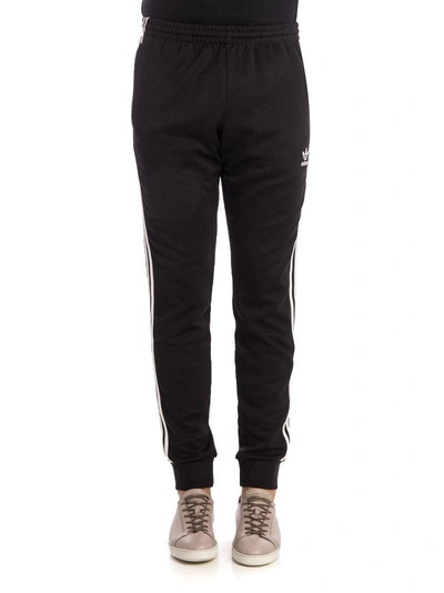 Shop Adidas Originals Sst Cuffed Jogging Trousers In Black