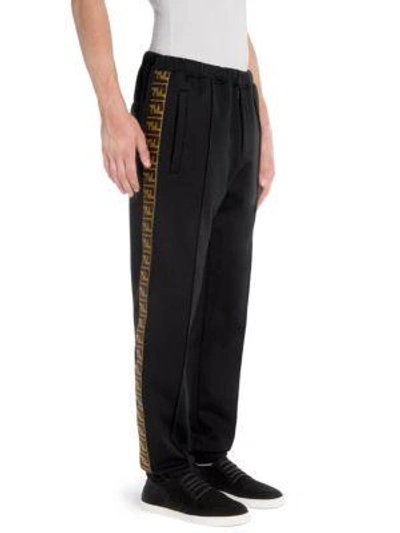 Shop Fendi Zecca Logo Tape Pants In Black