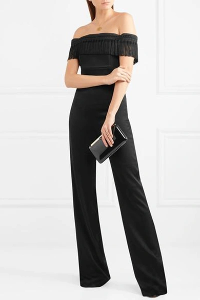 Shop Galvan Conquista Fringed Off-the-shoulder Satin Jumpsuit In Black