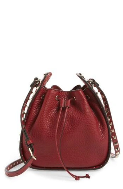 Shop Valentino Rockstud Leather Bucket Bag - Red In Rubin