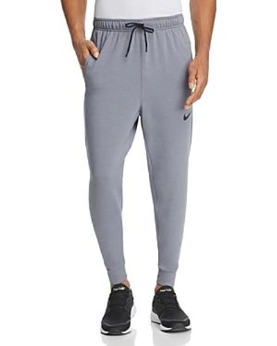 Shop Nike Dri-fit Regular Fit Training Pants In Gray/black
