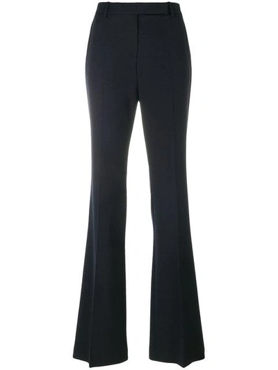 Shop Alexander Mcqueen Flared Pleated Trousers - Blue