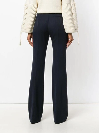 Shop Alexander Mcqueen Flared Pleated Trousers - Blue