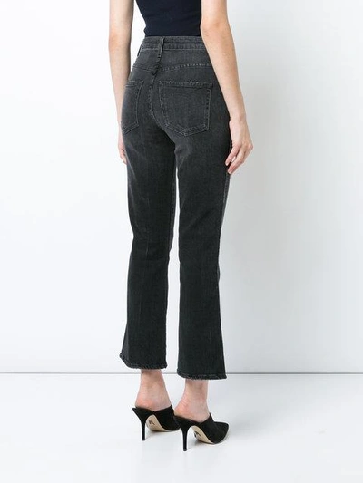 Shop Khaite Cropped Flared Jeans In Black