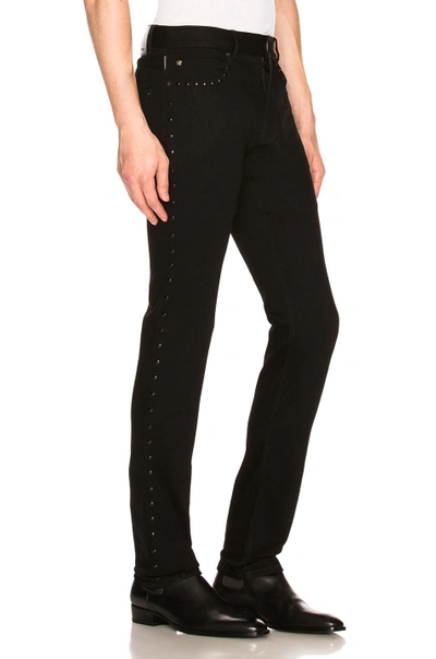Shop Versace Studded Jeans In Black