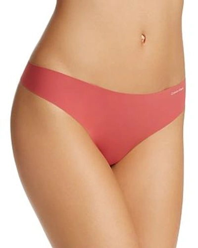 Shop Calvin Klein Invisibles Thong In Granada Red