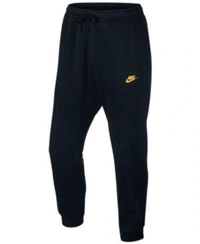 nike black and gold pants