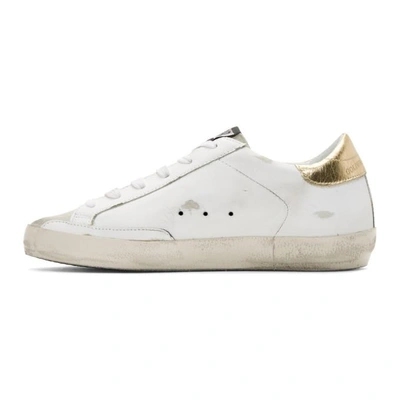 Shop Golden Goose White And Gold Superstar Sneakers In White-gold-