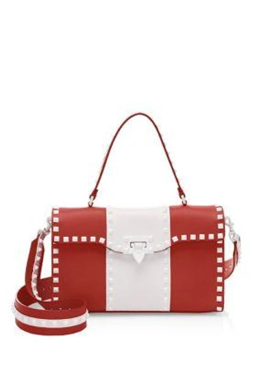 Shop Valentino Studded Leather Crossbody Bag In Red