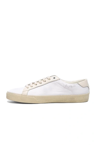 Shop Saint Laurent Embroidered Canvas Court Classic Sneakers In Cream. In Creme & Optic White