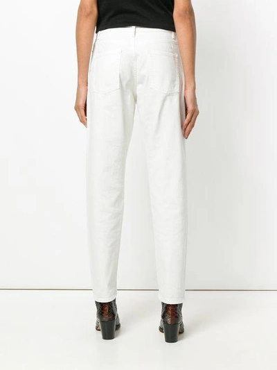 Shop Saint Laurent Tapered Leg Jeans In White